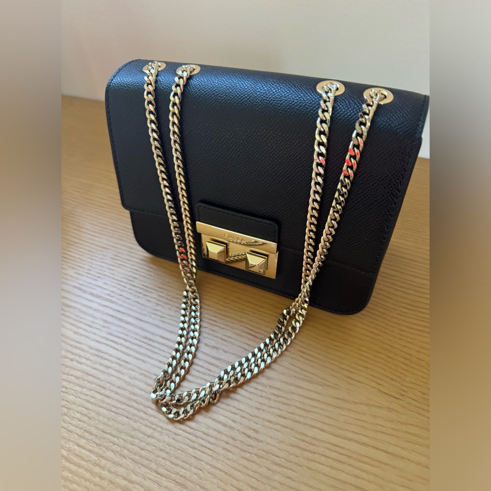 New without tags. Furla leather crossbody purse. Champagne gold hardware.